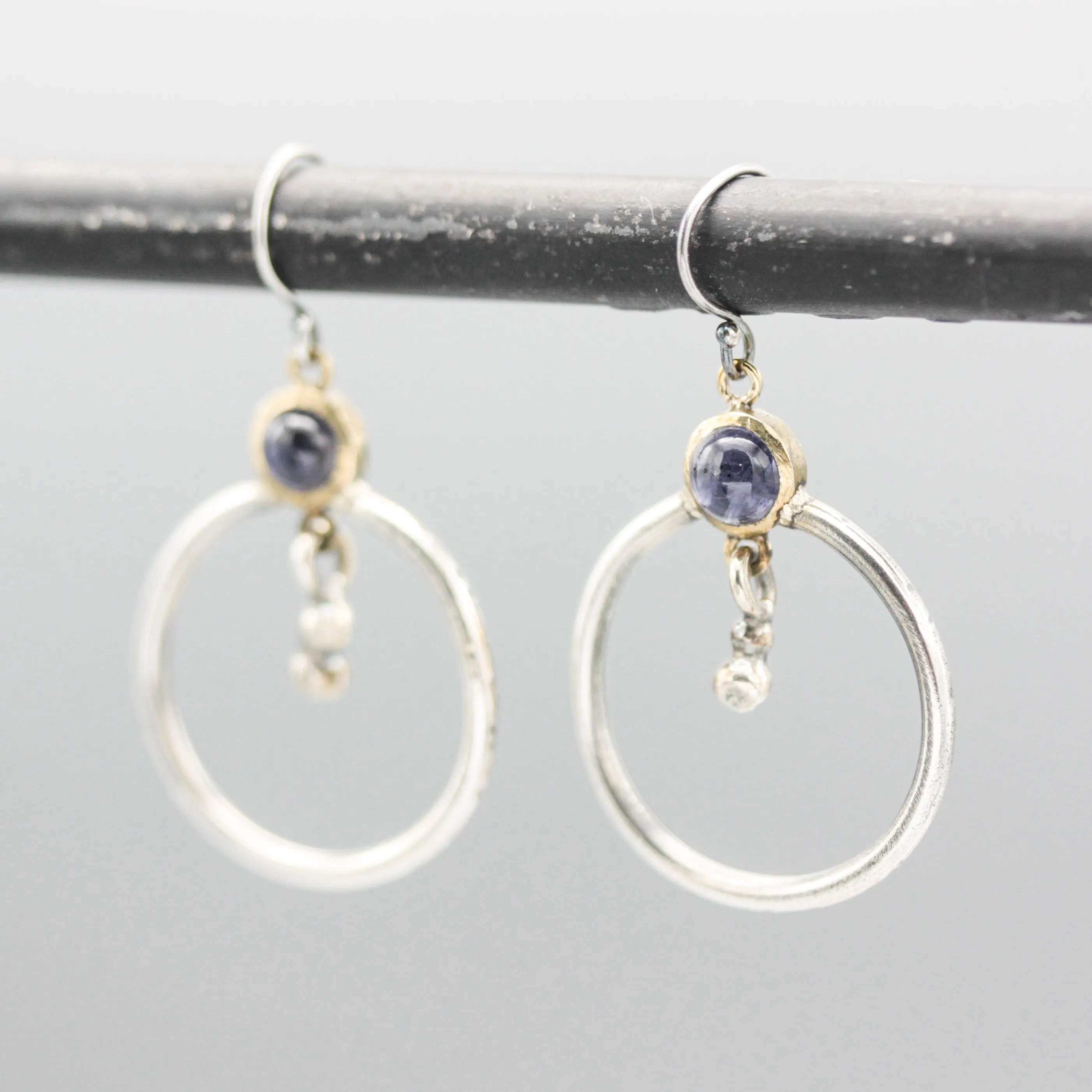 Earrings round amethyst in brass bezel setting with silver circle loop and silver beads on silver hooks style